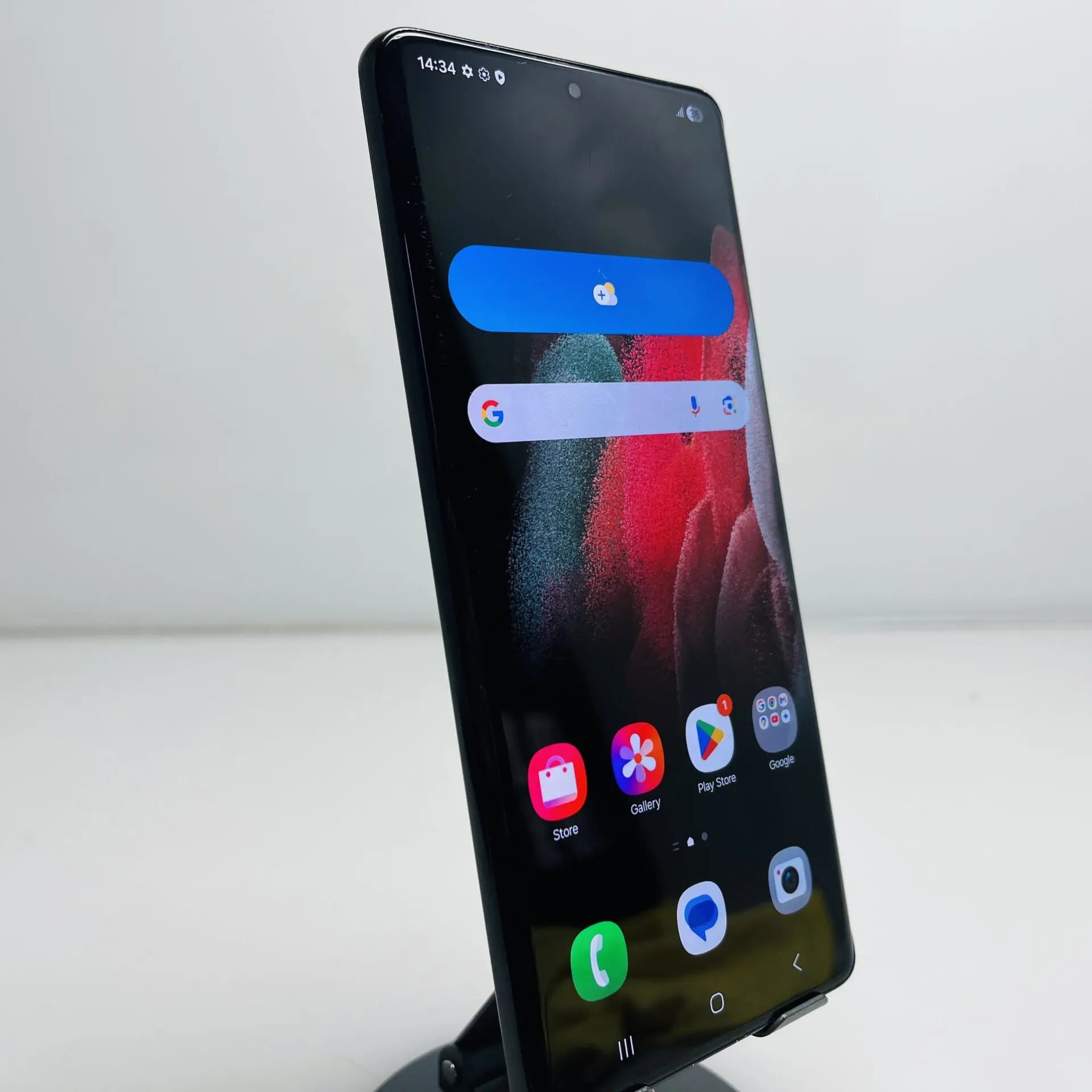 A black Samsung S21 ultra smartphone with a large front-facing screen, shown standing upright on a small display stand against a plain light background. From CronicX Store. Buy SAMSUNG HERE.